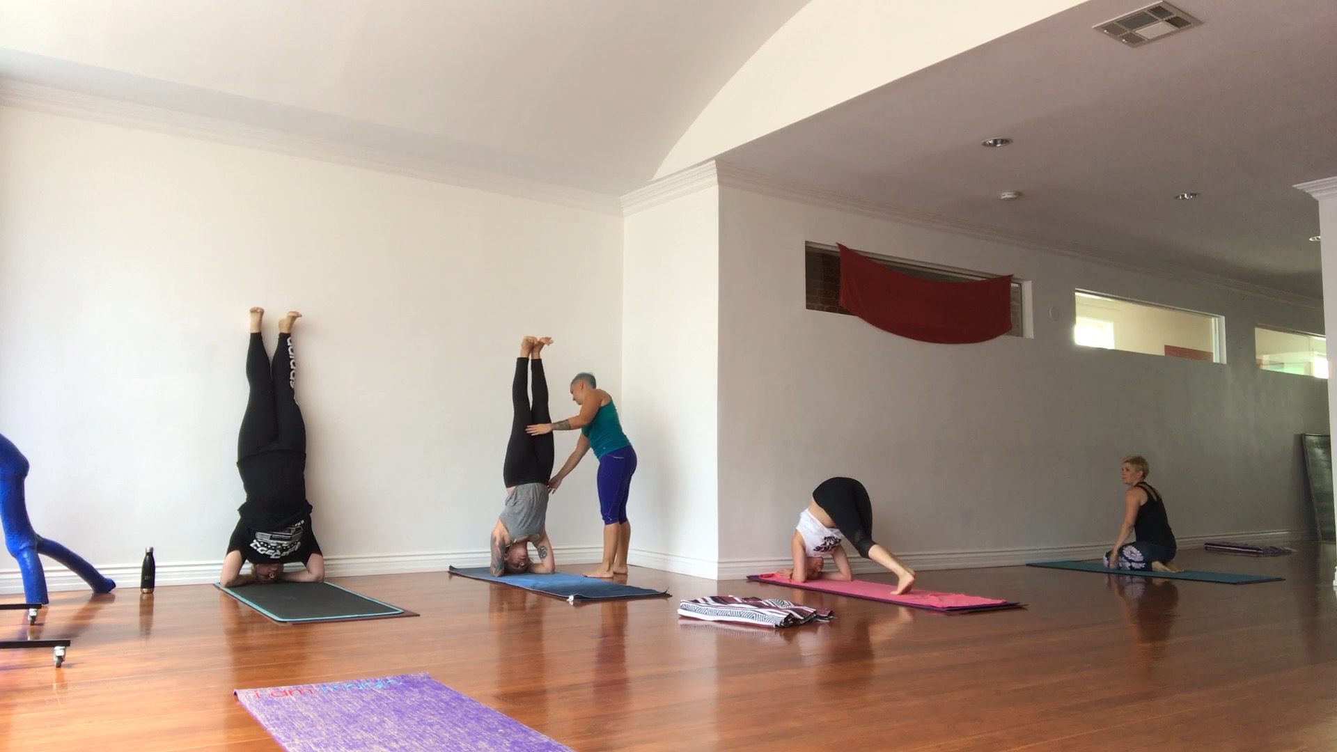 Assessing headstand practices at the wall before falling from them in the middle of the room. 